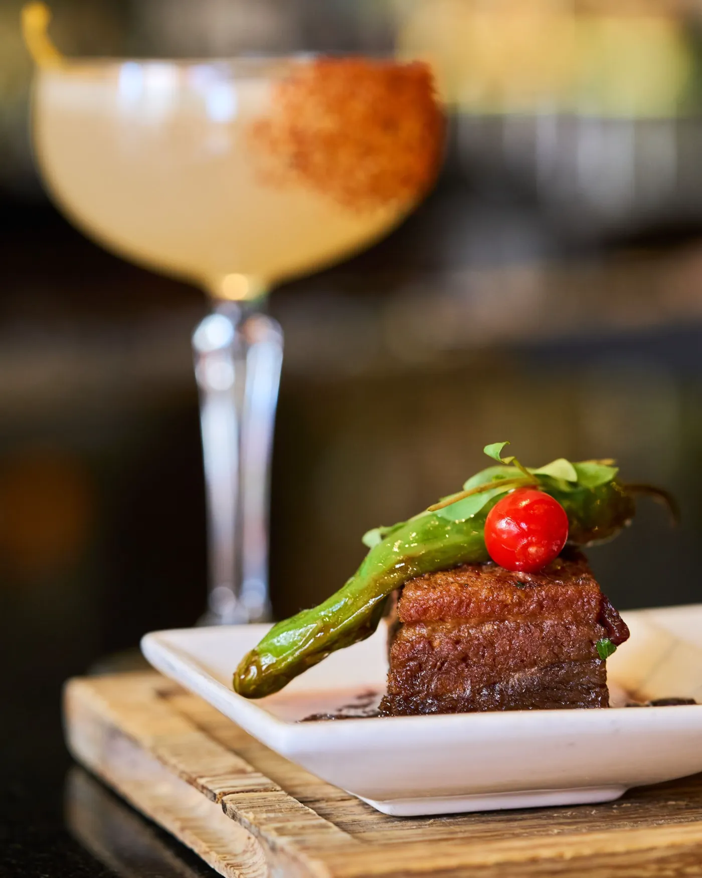 Braised pork belly with blistered shishito and a coupe cocktail at Casa del Toro