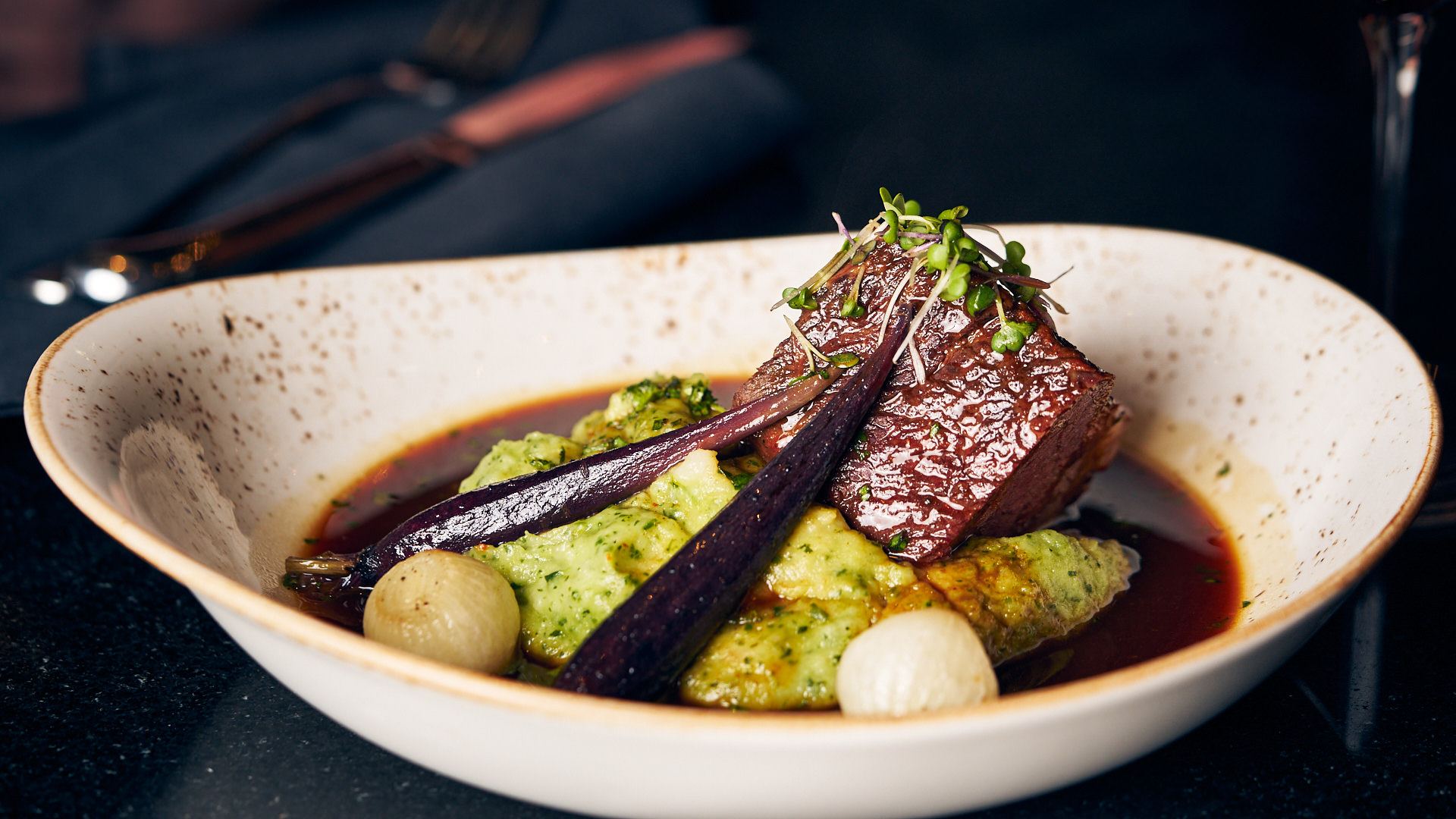 Braised short rib with pea purée and roasted heirloom carrots at Casa del Toro