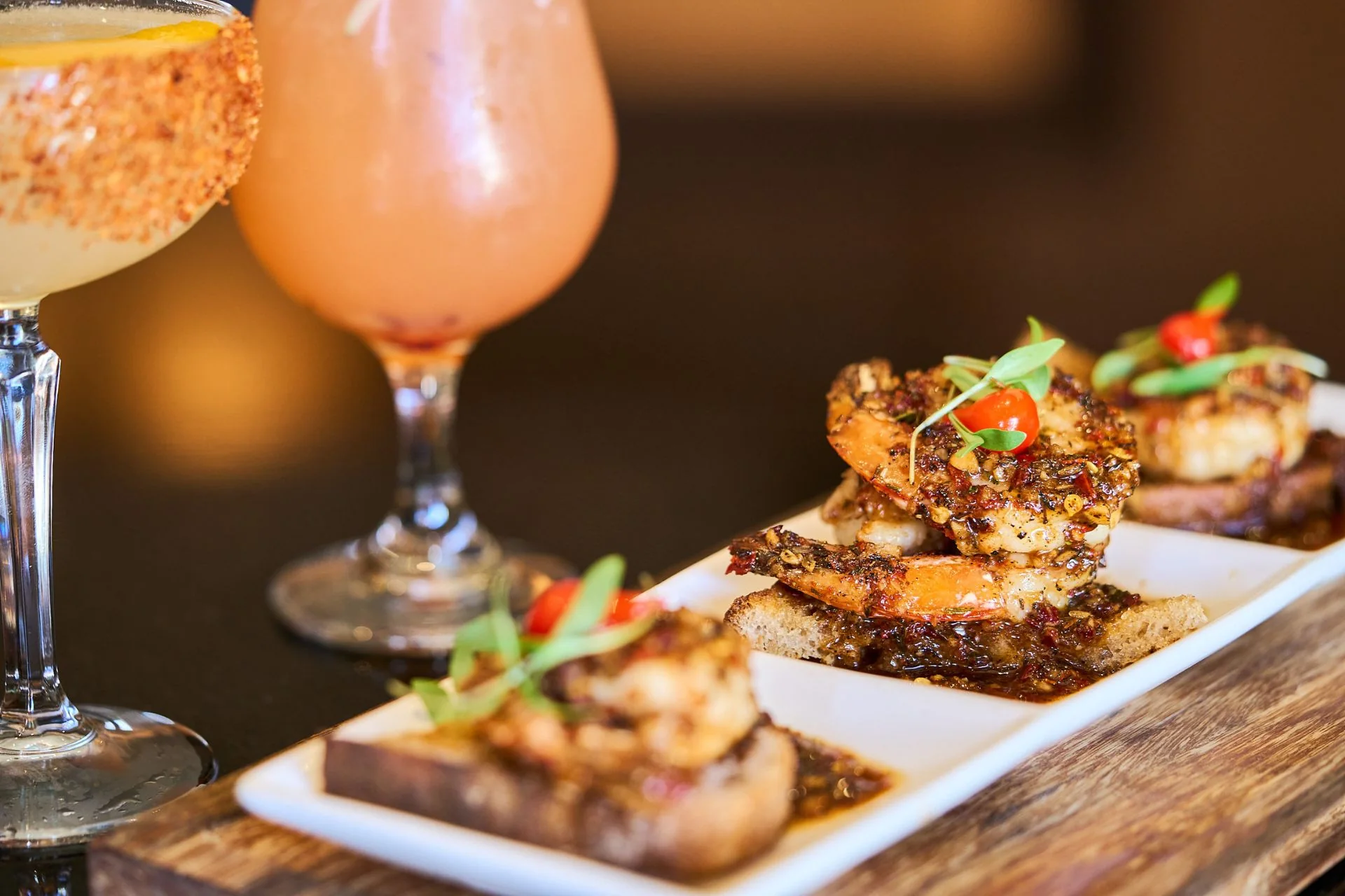 Shrimp plate served with a tropical cocktail